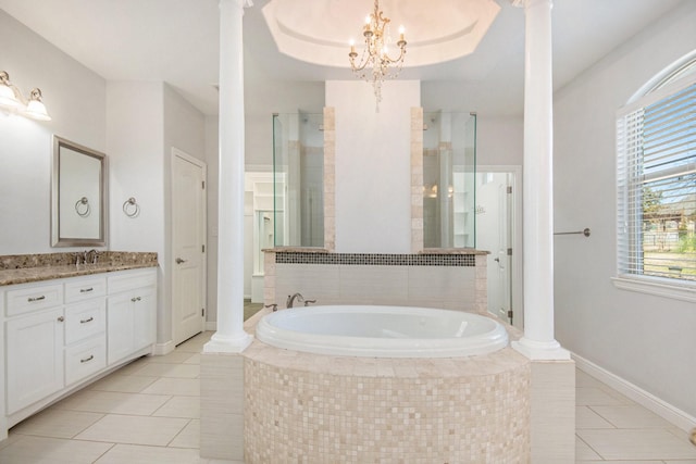 bathroom featuring decorative columns, tile patterned floors, vanity, and a chandelier