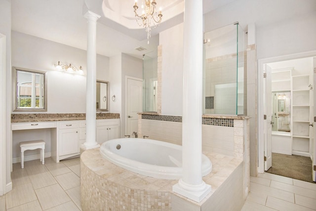 bathroom featuring tile patterned floors, decorative columns, vanity, and a chandelier