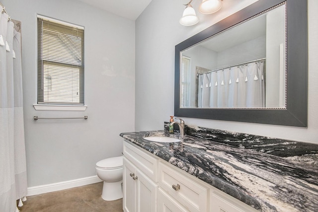 bathroom featuring vanity, toilet, and a wealth of natural light