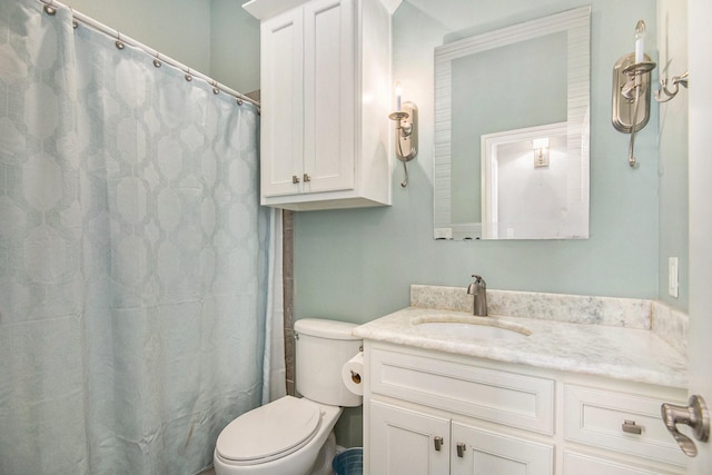 bathroom with vanity, toilet, and curtained shower