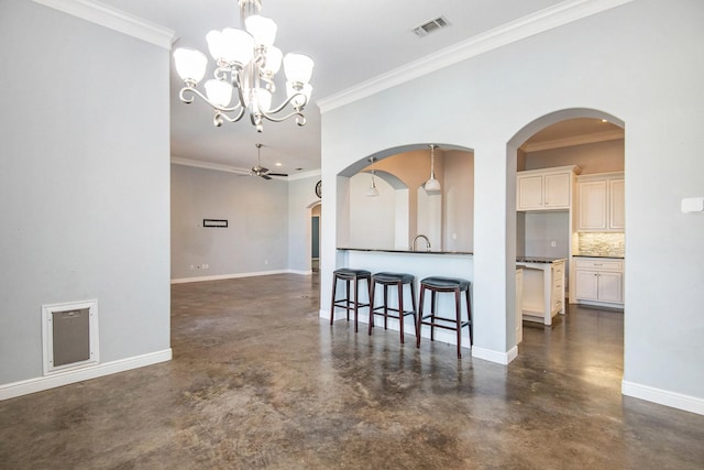 interior space featuring tasteful backsplash, decorative light fixtures, ceiling fan with notable chandelier, and ornamental molding