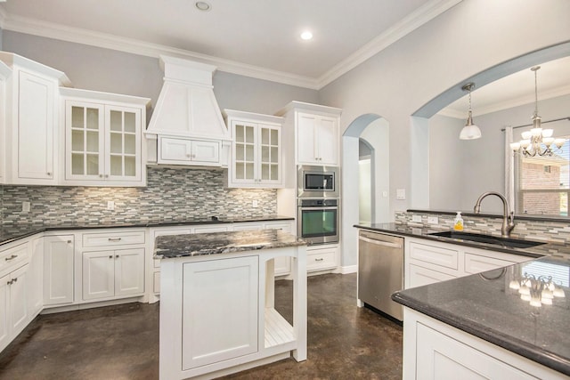 kitchen featuring white cabinetry, sink, decorative light fixtures, and appliances with stainless steel finishes