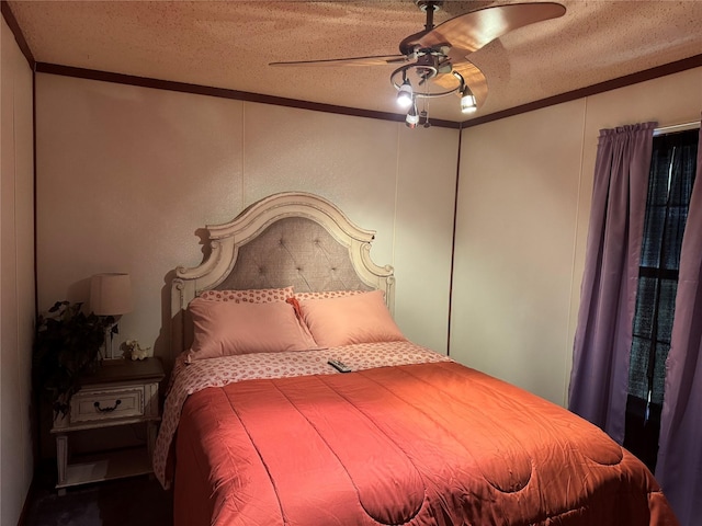 bedroom featuring ceiling fan, a textured ceiling, and ornamental molding