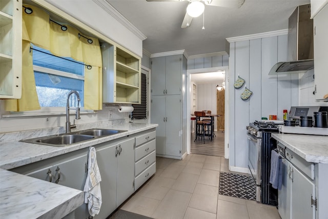 kitchen with light tile patterned flooring, wall chimney range hood, sink, ornamental molding, and gas stove