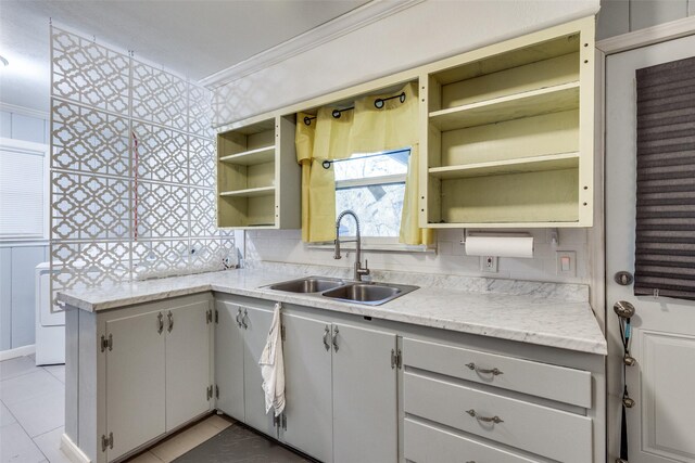 kitchen featuring tasteful backsplash, crown molding, sink, and white cabinets