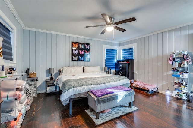 bedroom featuring crown molding, ceiling fan, and dark wood-type flooring