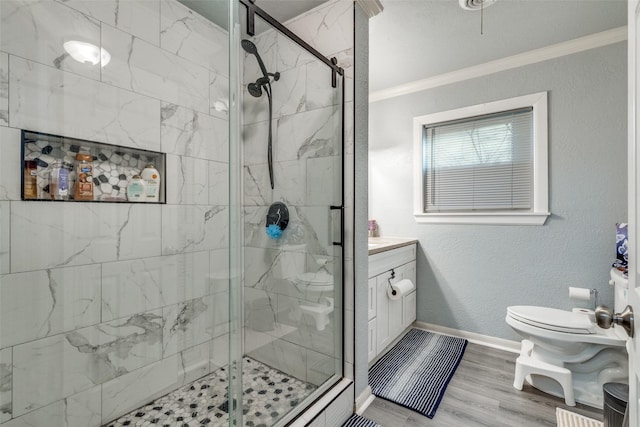 bathroom featuring vanity, crown molding, hardwood / wood-style flooring, toilet, and a shower with shower door