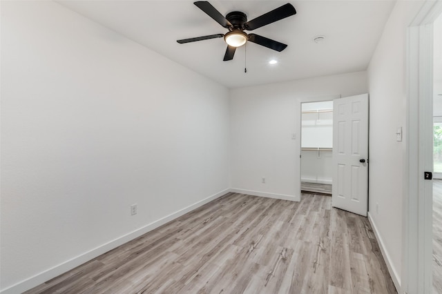 empty room featuring ceiling fan and light hardwood / wood-style flooring