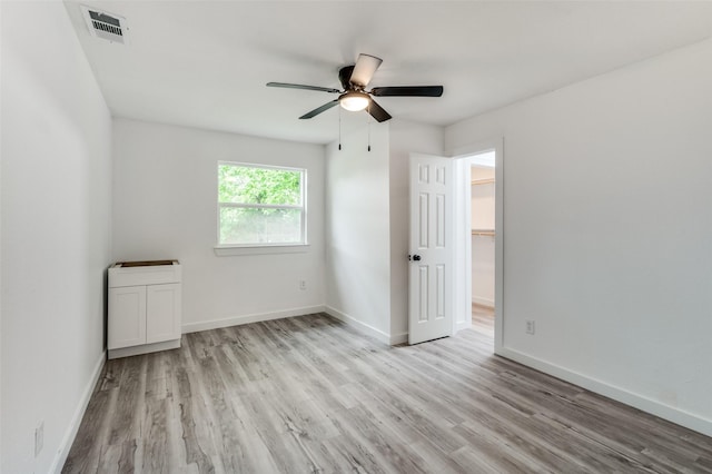 unfurnished room with ceiling fan and light hardwood / wood-style floors