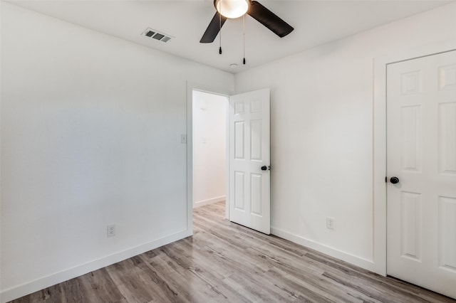 unfurnished bedroom with ceiling fan and light hardwood / wood-style floors