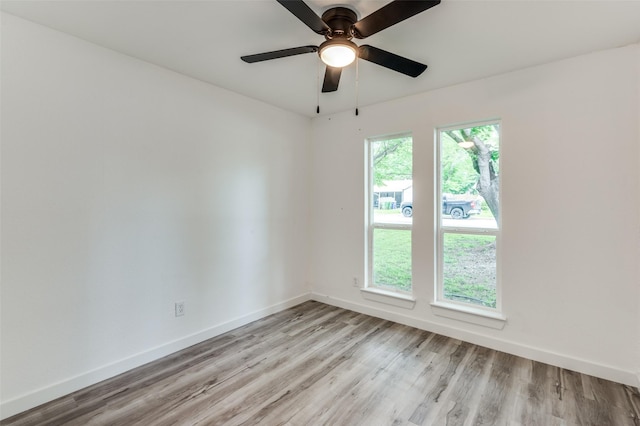 spare room with ceiling fan and light hardwood / wood-style floors