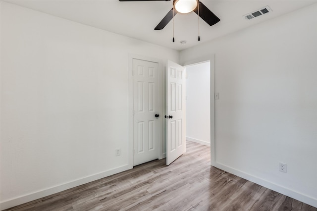 unfurnished room with ceiling fan and light wood-type flooring