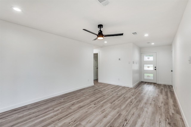 empty room with ceiling fan and light wood-type flooring