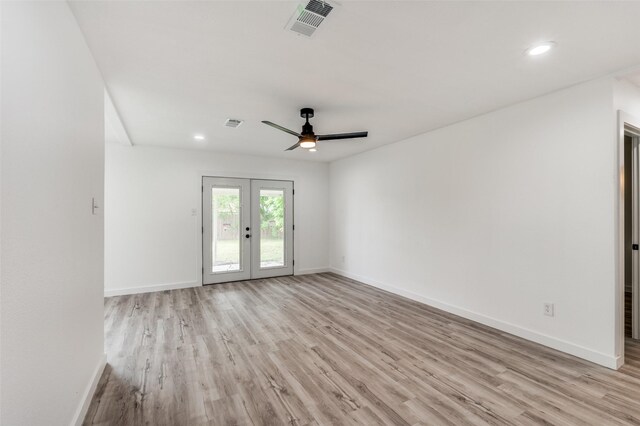 empty room featuring ceiling fan, french doors, and light wood-type flooring