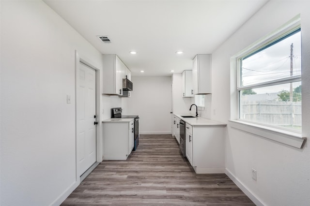 kitchen with white cabinetry, sink, stainless steel appliances, and light wood-type flooring