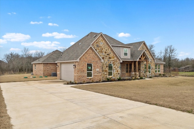 view of front of property featuring covered porch, an attached garage, concrete driveway, stone siding, and a front lawn