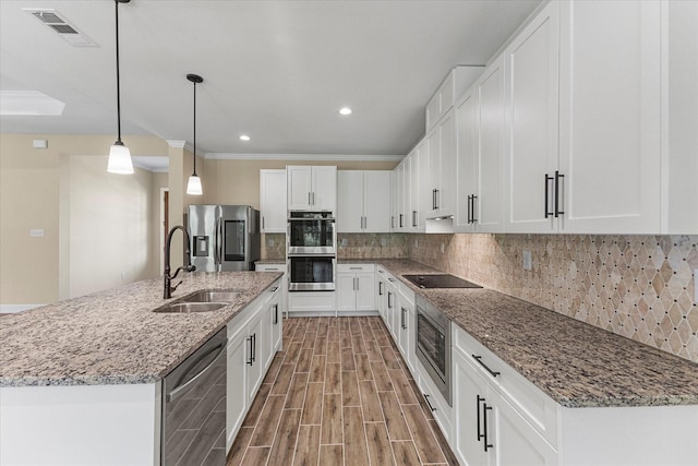 kitchen featuring recessed lighting, visible vents, a sink, stainless steel appliances, and white cabinets