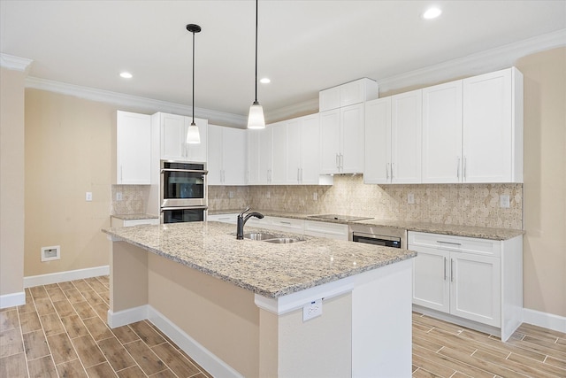 kitchen featuring black electric cooktop, double oven, wood finish floors, and a sink