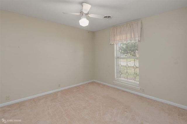 carpeted spare room with ceiling fan