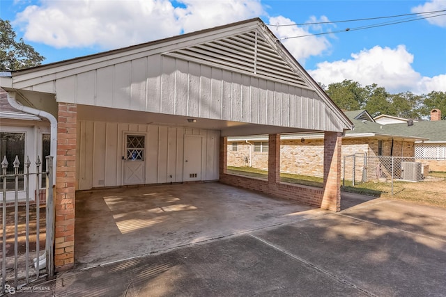 view of property exterior featuring central AC unit and a carport