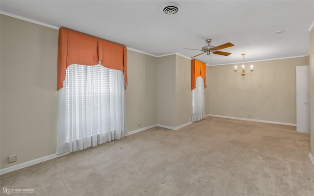 spare room with light colored carpet, crown molding, and a wealth of natural light