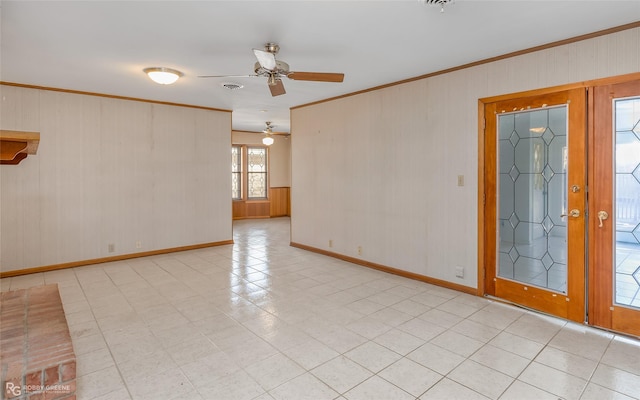 spare room with ceiling fan, crown molding, and french doors