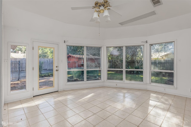 unfurnished sunroom with ceiling fan