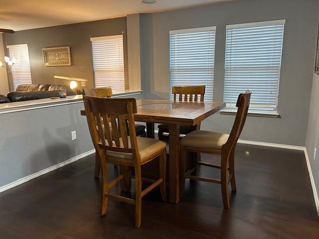 dining room featuring baseboards and wood finished floors