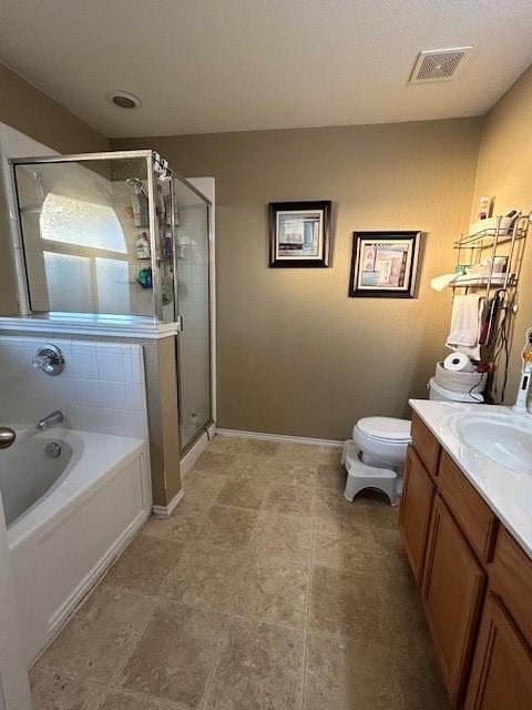 bathroom with visible vents, toilet, a stall shower, vanity, and a bath