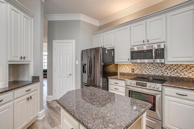 kitchen with white cabinets, stainless steel appliances, and a center island