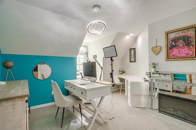 office with lofted ceiling and light colored carpet