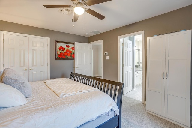 carpeted bedroom with two closets and ceiling fan