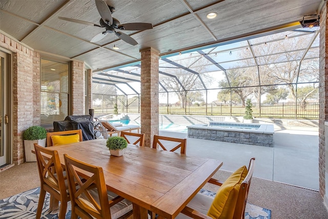 view of patio / terrace featuring a swimming pool with hot tub, a lanai, ceiling fan, and area for grilling