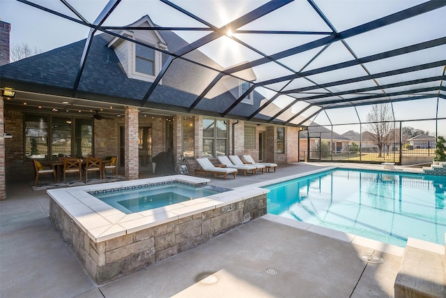 view of swimming pool with a lanai, a patio, and an in ground hot tub