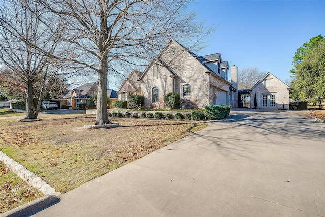 view of side of property with a garage and french doors