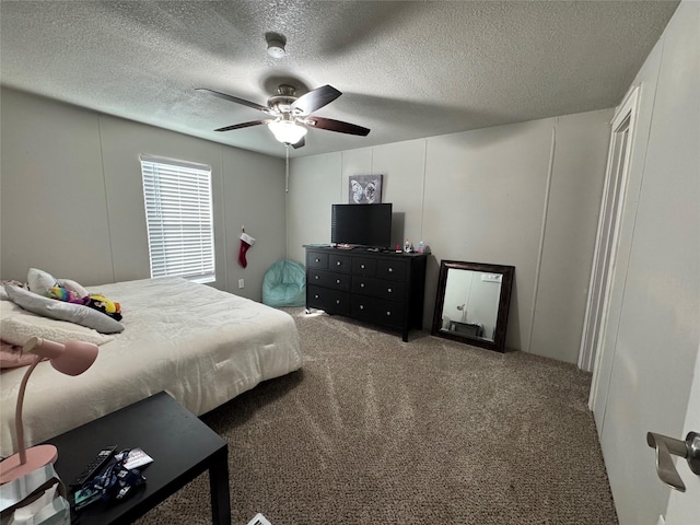 bedroom with a textured ceiling, ceiling fan, and carpet flooring