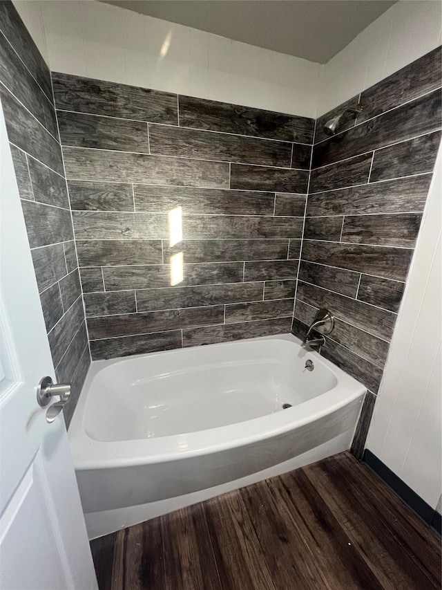 full bath featuring wood finished floors and bathing tub / shower combination