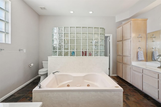 bathroom featuring a tub, vanity, and toilet