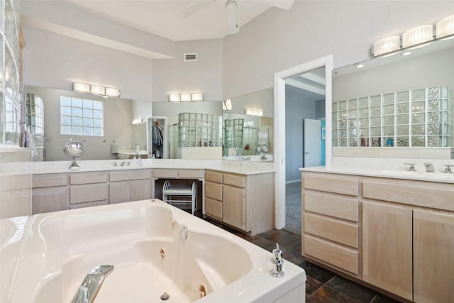 bathroom featuring a washtub, vanity, and ceiling fan