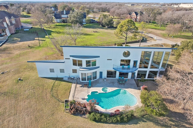 rear view of house with a balcony and a patio