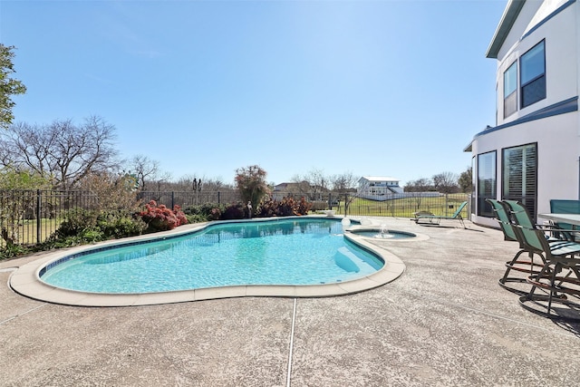 view of swimming pool featuring an in ground hot tub and a patio