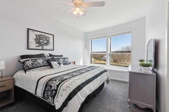 bedroom with ceiling fan and dark carpet