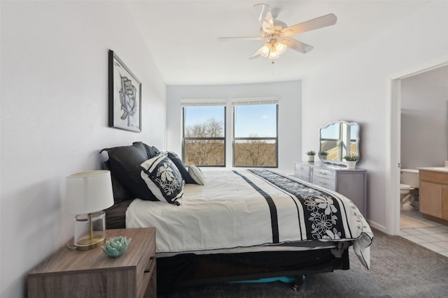 carpeted bedroom with ceiling fan and ensuite bathroom