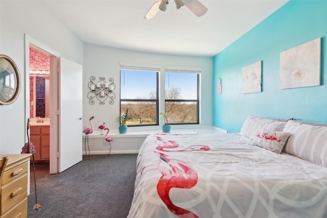 bedroom featuring ensuite bath, ceiling fan, sink, and dark carpet