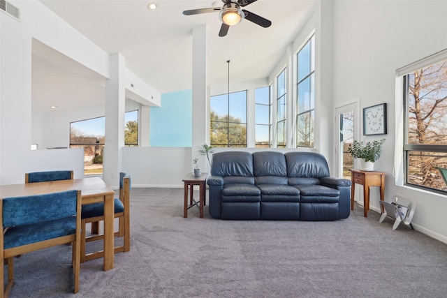 carpeted living room with ceiling fan and a healthy amount of sunlight