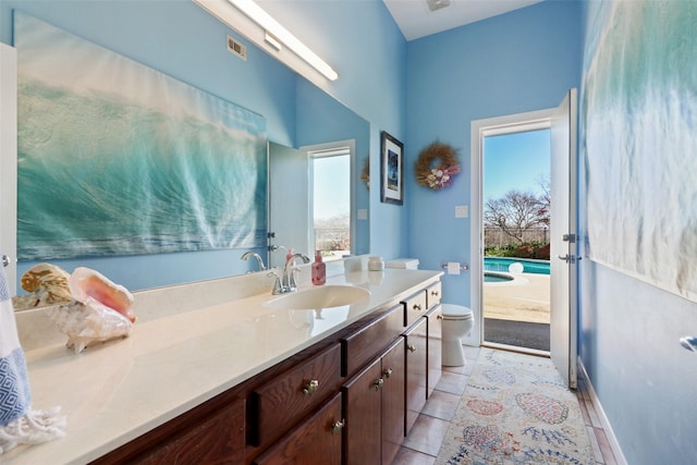 bathroom with tile patterned floors, vanity, and toilet