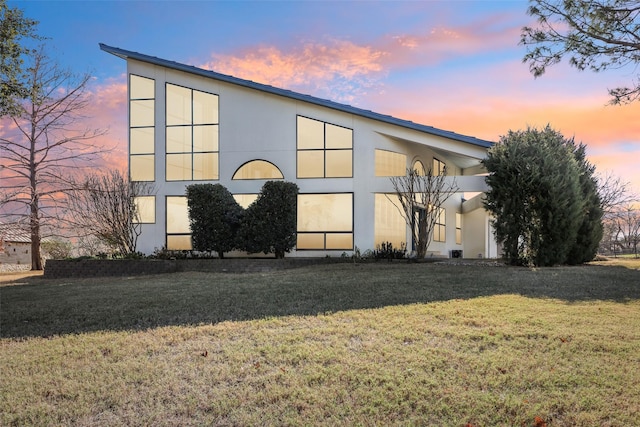 3611 Sunrise Bay Pt, Little Elm, TX 75068 - property exterior at dusk with stucco siding and a lawn