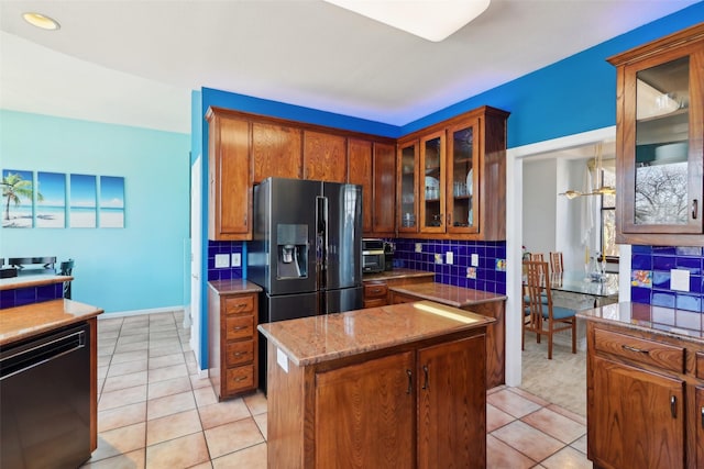 kitchen featuring stainless steel refrigerator with ice dispenser, backsplash, dishwasher, a center island, and light tile patterned flooring