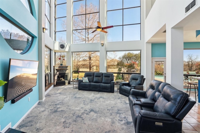 3611 Sunrise Bay Pt, Little Elm, TX 75068 - carpeted living room with a high ceiling, plenty of natural light, a ceiling fan, and a fireplace