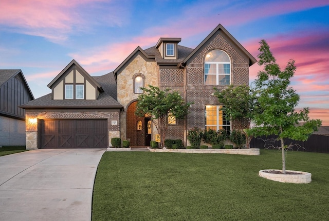 view of front of home with a garage and a yard